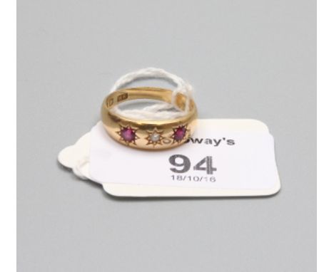 An Edwardian three stone ruby and diamond ring, gypsy set within a plain 18ct gold band