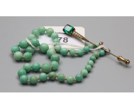 A small graduated jade bead necklace, 33cm, and a costume stick pin