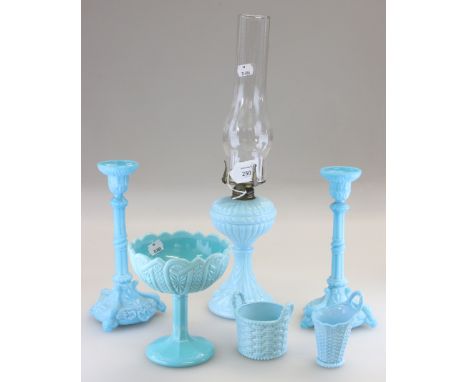 A garniture of 19th century pale blue pressed satin glass, comprising a pair of candlesticks and a paraffin lamp, each with m
