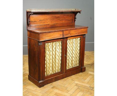 An early 19th century rosewood chiffonier of small proportions, having a brass gallery rail over a panelled shelf, the base w