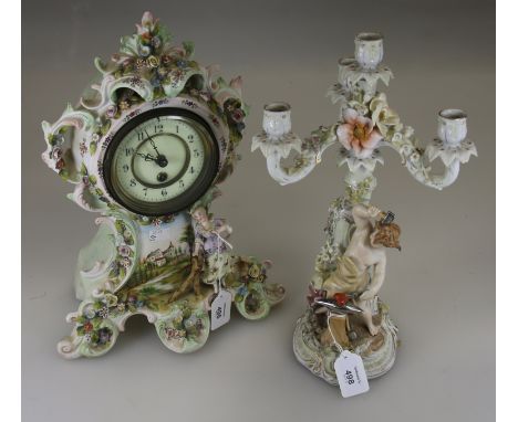 A late 19th century continental eight day porcelain mantel timepiece, the leafy florally applied balloon shape case painted w