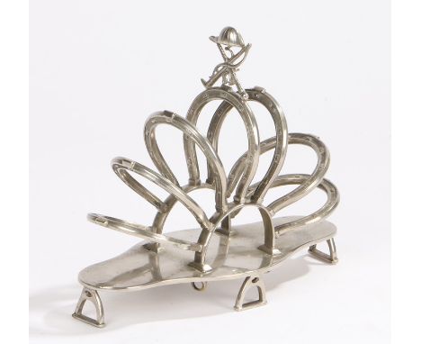 Novelty equestrian themed silver plated toast rack, the pierced finial in the form of a jockey's cap and two crossed whips, t