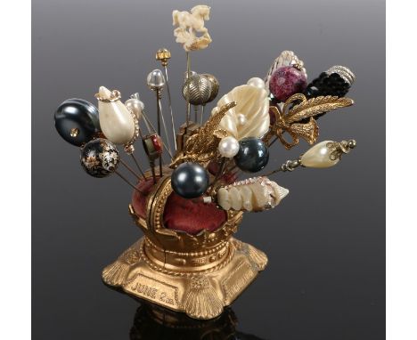 Collection of twenty-seven assorted hatpins and stick pins in a commemorative crown shaped hat pin holder for the coronation 