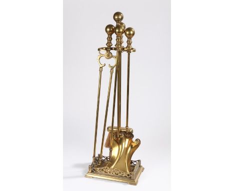 Art Nouveau brass companion set, consisting of shovel, tongs, poker and brush, all with orb form finials, housed on a brass s