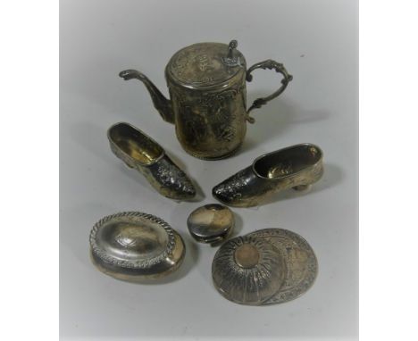 A selection of silver itemsTo include a jockey cap caddy spoon, two silver pill boxes, a German silver miniature teapot and o