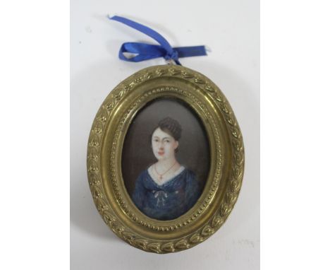 A 19th Century French oval miniature portrait Watercolour and gouache, unsigned, set in a pressed brass frame, height in tota