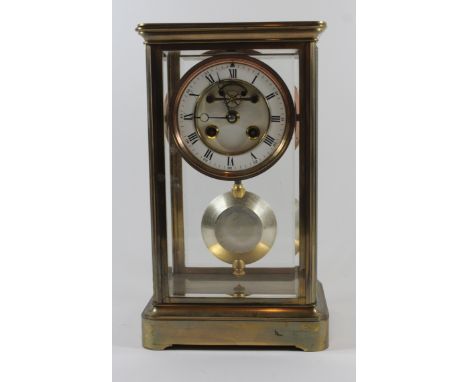 A 20th Century mantel clock The circular face with white enamel chapter ring with Roman and Arabic numeral to a brass eight d