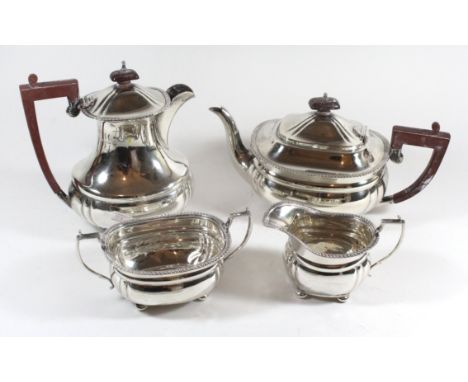 A silver tea set Comprising a teapot, coffee pot, milk jug and sugar pot each raised on four bun feet with reeded decoration 