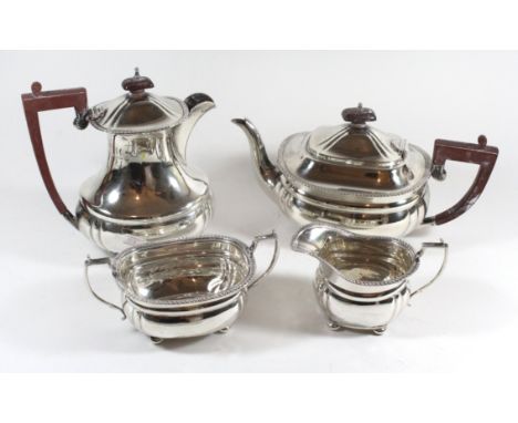 A silver tea set Comprising a teapot, coffee pot, milk jug and sugar pot each raised on four bun feet with reeded decoration 