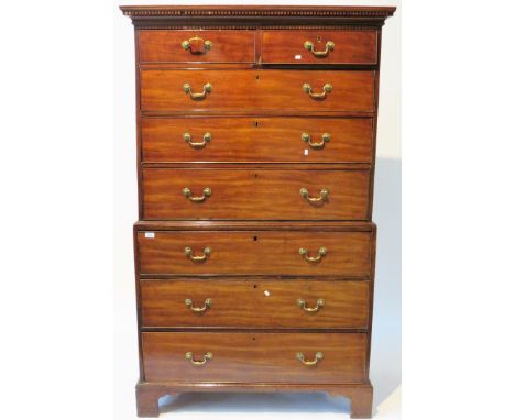 A George III mahogany chest on chestThe top section with moulded dentil cornice over two short and three long drawers, the ba