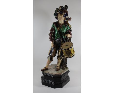 A large and impressive 19th Century Majolica glazed figureModelled in the form of a Cavalier playing a drum, indistinct impre