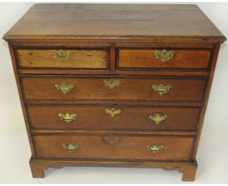 A George III oak and mahogany crossbanded chest of two short and three long drawersRaised on bracket feet, fitted throughout 