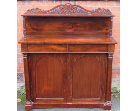 An early Victorian rosewood chiffonierWith arched back section with single shelf and carved detail over a base with two drawe