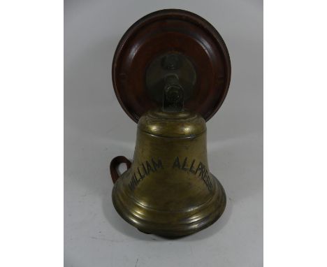 A vintage brass ships bell, marked William AllpressMounted on a turned wooden back board, bell diameter 19.5cm.  A vintage br