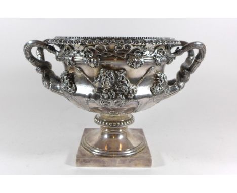 An Edward VII hallmarked silver Warwick vaseDecorated in relief with portrait busts, grapes and foliate by Edward Barnard & S