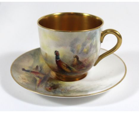 A Royal Worcester hand painted cup and saucerDecorated with Pheasants in landscape by James Stinton, signed, puce factory mar