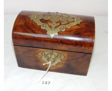 A Victorian rosewood dome shaped tea caddy with brass decoration opening to reveal to lidded compartments.     CONDITION REPO