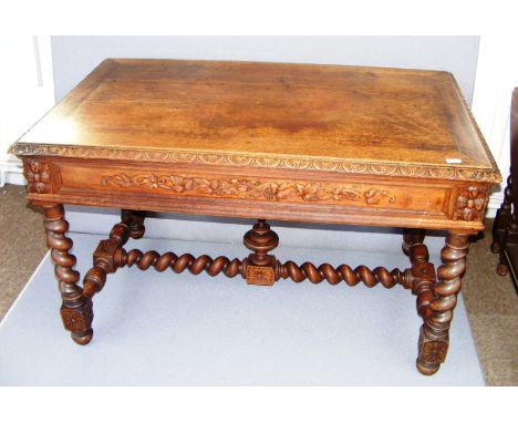 A Victorian heavily carved oak table in the Gothic style with barley twist legs, a cross stretcher with finial, measuring 49"