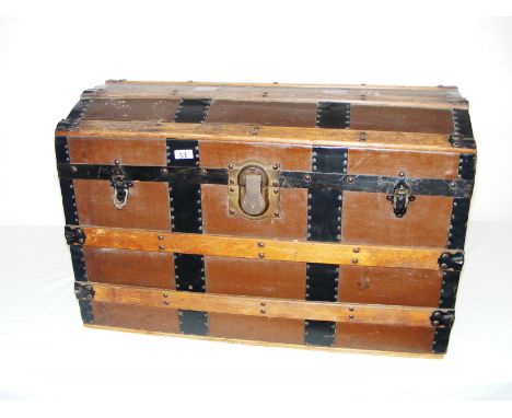 Eagle Lock Company, an early 20th century "Treasure Chest" style trunk, made from wood with cross banded metal, measuring 32"