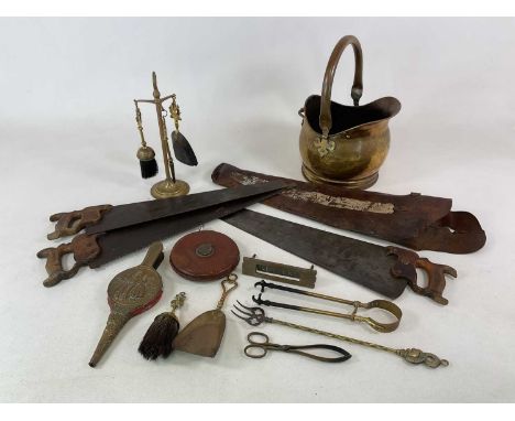 A group of mixed metalware, including three wood saws contained in a leather tool case, companion sets, a leather clad tape m