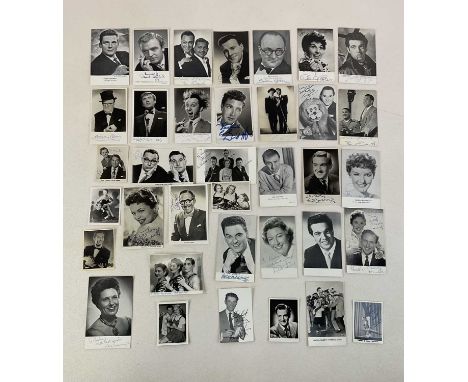 A group of vintage black and white photographic postcards of celebrities, many signed, including Morecambe and Wise, a handfu