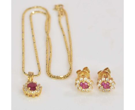 An 18ct yellow gold chain with diamond and ruby pendant drop and a pair of yellow metal ruby and diamond ear studs en suite, 