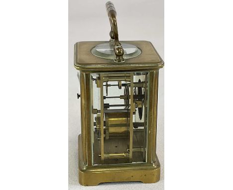 A circa 1900 French brass carriage clock, with Roman numerals to the white enamel dial, height when handle dropped 12cm.
