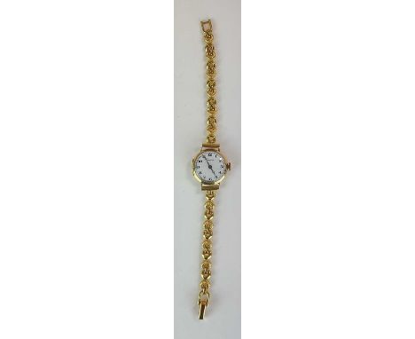 VERTEX; a lady's vintage 9ct gold cased wristwatch head, on associated gilt metal bracelet.