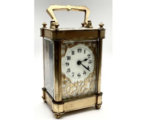 A circa 1900 French brass carriage clock, with elaborate detail to the dial set with Arabic numerals, the door numbered 187, 
