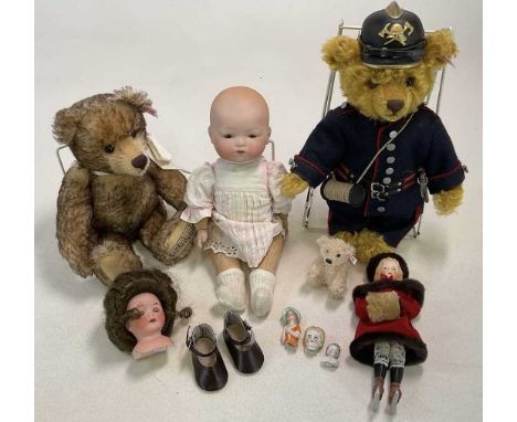 STEIFF; three bears, one musical, one as a fireman and one small collector edition, with a Armand Marseille baby doll on a cl