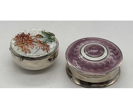 A George V hallmarked silver and pale lilac enamel decorated pill box, the circular pull-off lid with bands of pale lilac and