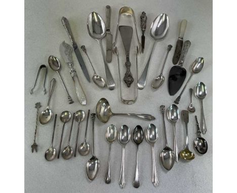A group of silver flatware including a pair of 18th century tablespoons (marks obscured), three pairs of sugar tongs, a set o