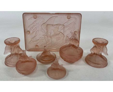 A blush pink glass dressing table set, to include two candle holders, ring and trinket dish, a large and small covered bowl, 