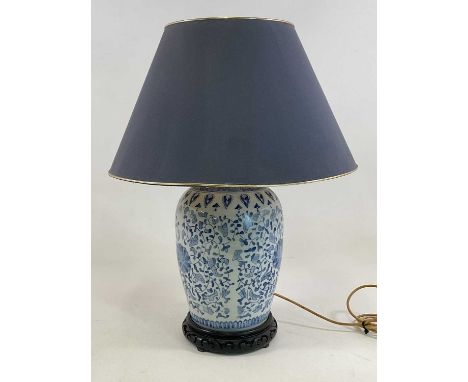 A Chinese ceramic blue and white table lamp with pierced ebonised wooden base and shade, height 66cm.