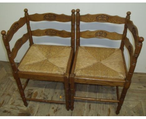 Pair of oak ladder back corner chairs with rush seats on turned supports (2)