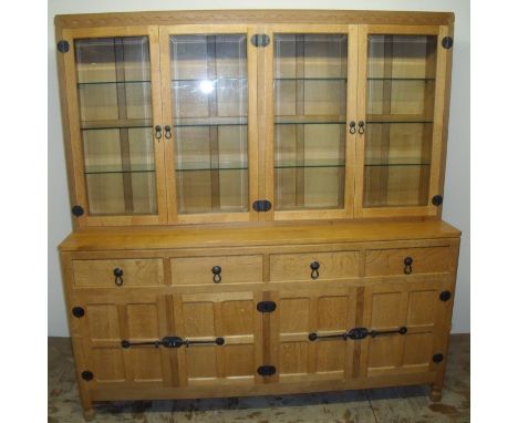 Robert Thompson 'Mouseman' oak dresser with four upper glazed bevelled edged panelled doors revealing three tier shelf interi