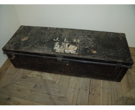 Large Japped metal rectangular officers travelling trunk with heavy lever action lock and traces of paper label to the top fo