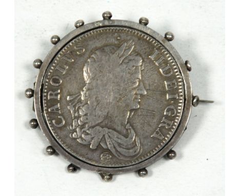 CHARLES II SILVER CROWN COIN 1662, dated on the reverse, first bust with rose below, now revolving in a silver coloured metal