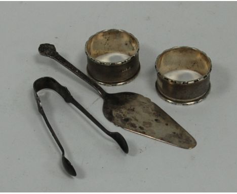 PAIR OF ENGINE TURNED SILVER NAPKINS RINGS, circular with raised borders, Birmingham 1938 and a small SILVER TART SERVER  and