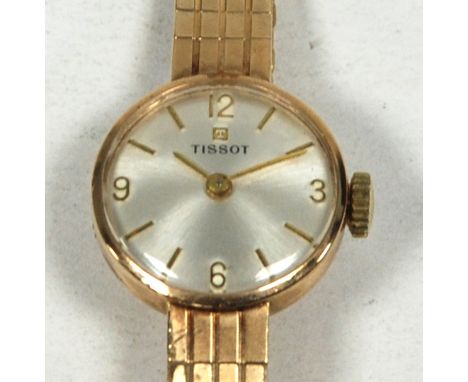 LADY'S 'TISSOT' 9ct GOLD WRIST WATCH, with mechanical movement, circular silvered dial with integral 9ct gold flexible bracel