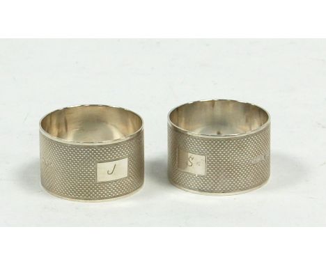 GEORGE VI PAIR OF ENGINE TURNED SILVER NAPKIN RINGS, initialled, Sheffield 1943, 2.5oz 