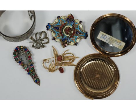 BROAD HINGE OPENING BANGLE, the top foliate scroll engraved and with presentation inscription dated 1940, 1 1/4" wide, mark '