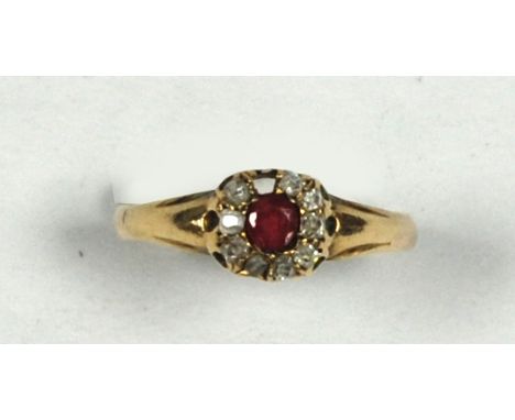 A SMALL ANTIQUE GOLD CLUSTER RING, set with a small centre circular ruby and surround of nine tiny diamonds (one missing) 