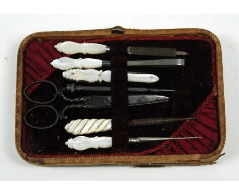 VICTORIAN MOROCCO FITTED MANICURE BOX, containing five manicure and needlework implements with carved mother O'pearl handles;