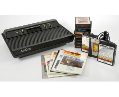 An Atari 2000 (model CX-2600AP) console, AV and power cables, joystick, manual, including eight game cartridges with manuals,