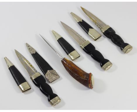 Three Scottish Sgian Dubh, the composite hilt with woven decoration, embossed crown pommel, leather scabbard, 18cm together w