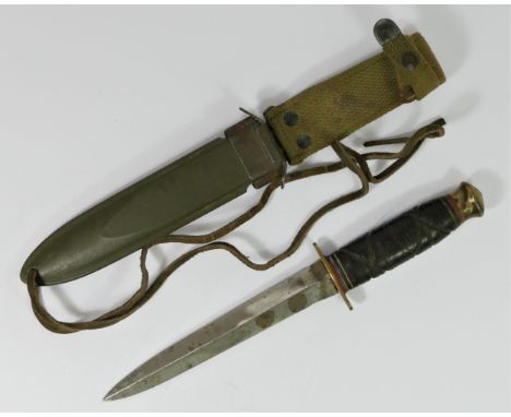 An American USM8 BMCO bayonet knife, with metal scabbard and material fitting, blade 17cm. 