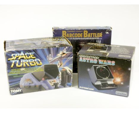 Three electronic tabletop games, boxed, to include Grandstand Astro Wars (manual), Tomy Space Turbo (no manual) and Commerce 