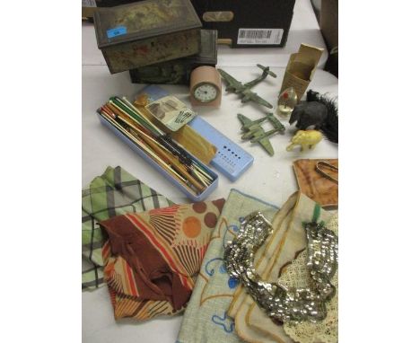 A mixed lot to include a peach coloured glass dressing table clock, various knitting needles, two brass model aeroplanes and 