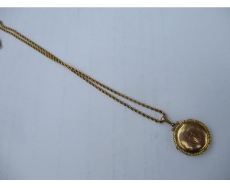 A 9ct gold locket and a yellow metal chain 